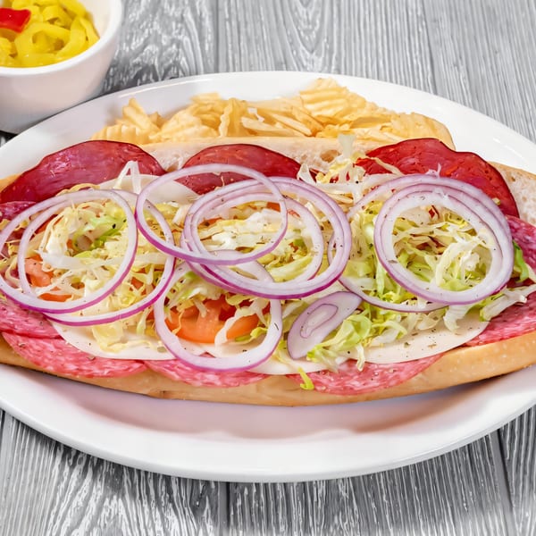 A Tony Sopranos Italian sub with salami, pepperoni, cheese, lettuce, tomato, and red onion.